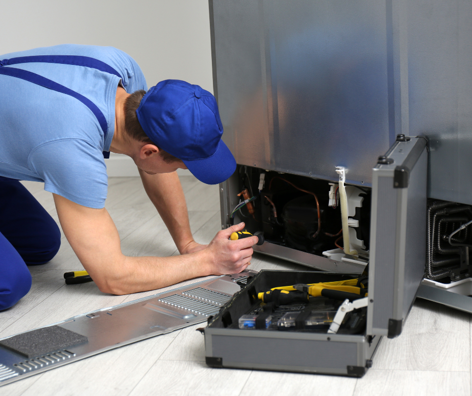 Technician repairing a Wolf appliance, using tools and inspecting internal components, emphasizing the importance of preparation for efficient service.